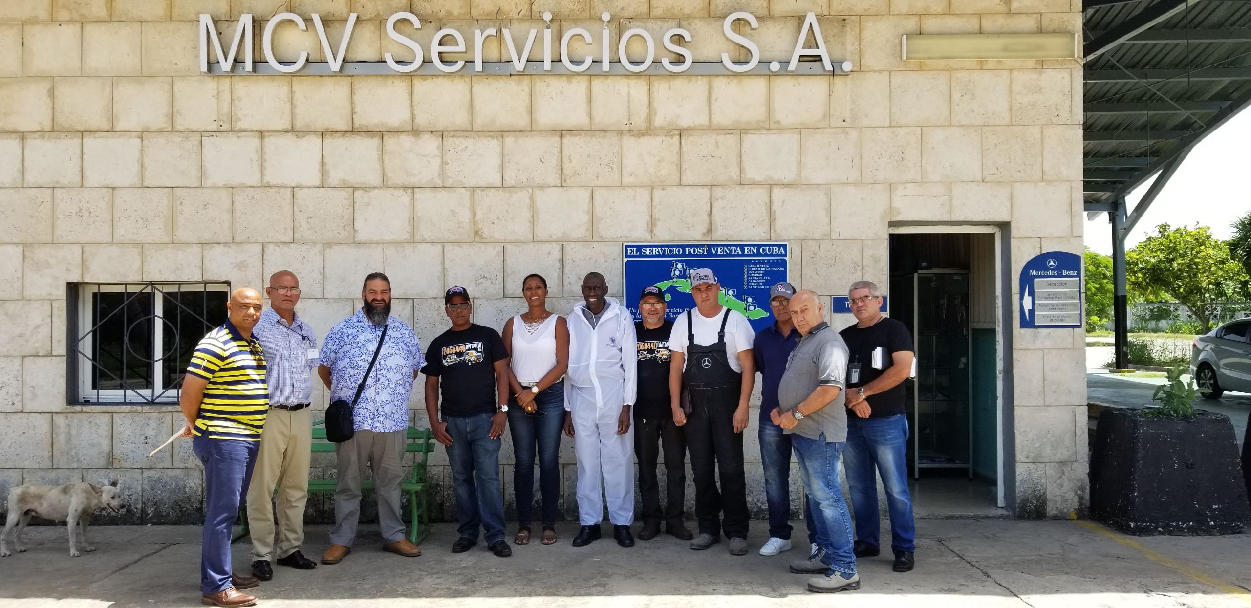 Peter Padmore, Technical Representative of Automotive Art, poses with painters after the workshop in Havana, Cuba